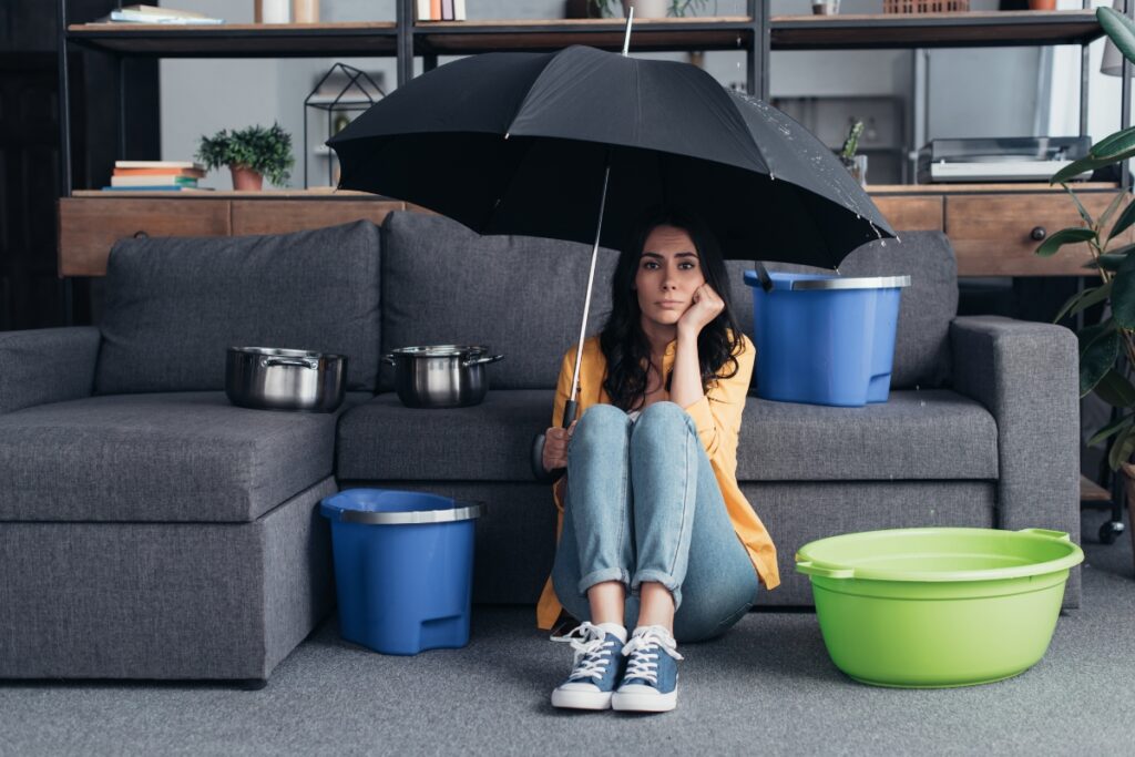 Pensive brunette girl sitting on floor with umbrella NL